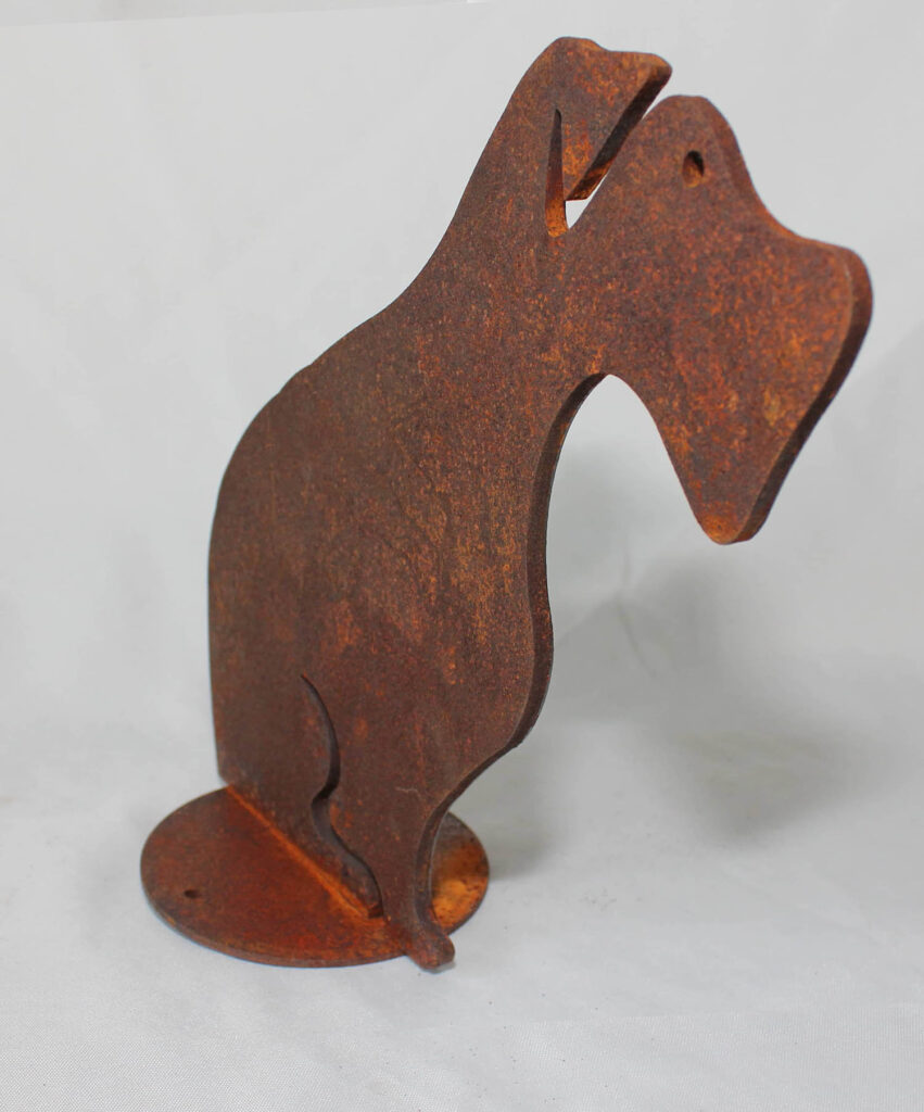 An oxidised stell dog figure, standing in a photo-setup