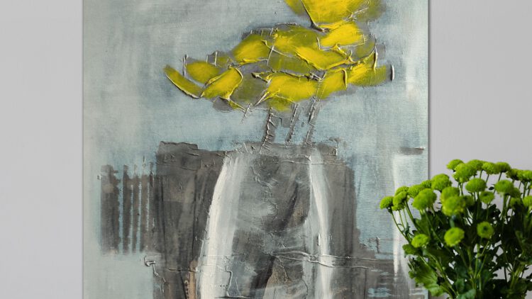 The yellow flower painting standing on the wooden floor, next to a flower vase.